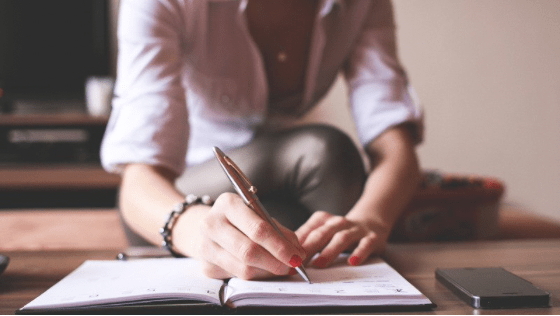 Photo of woman writing in her journal.